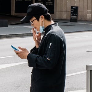 Man smoking while checking phone