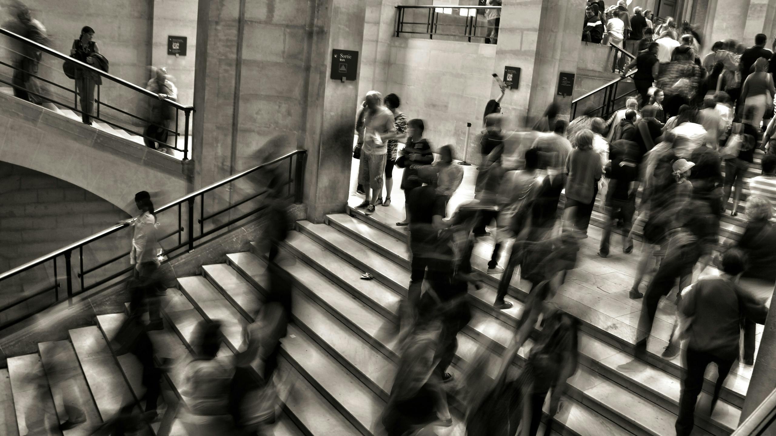 Crowd walking in busy stairwell