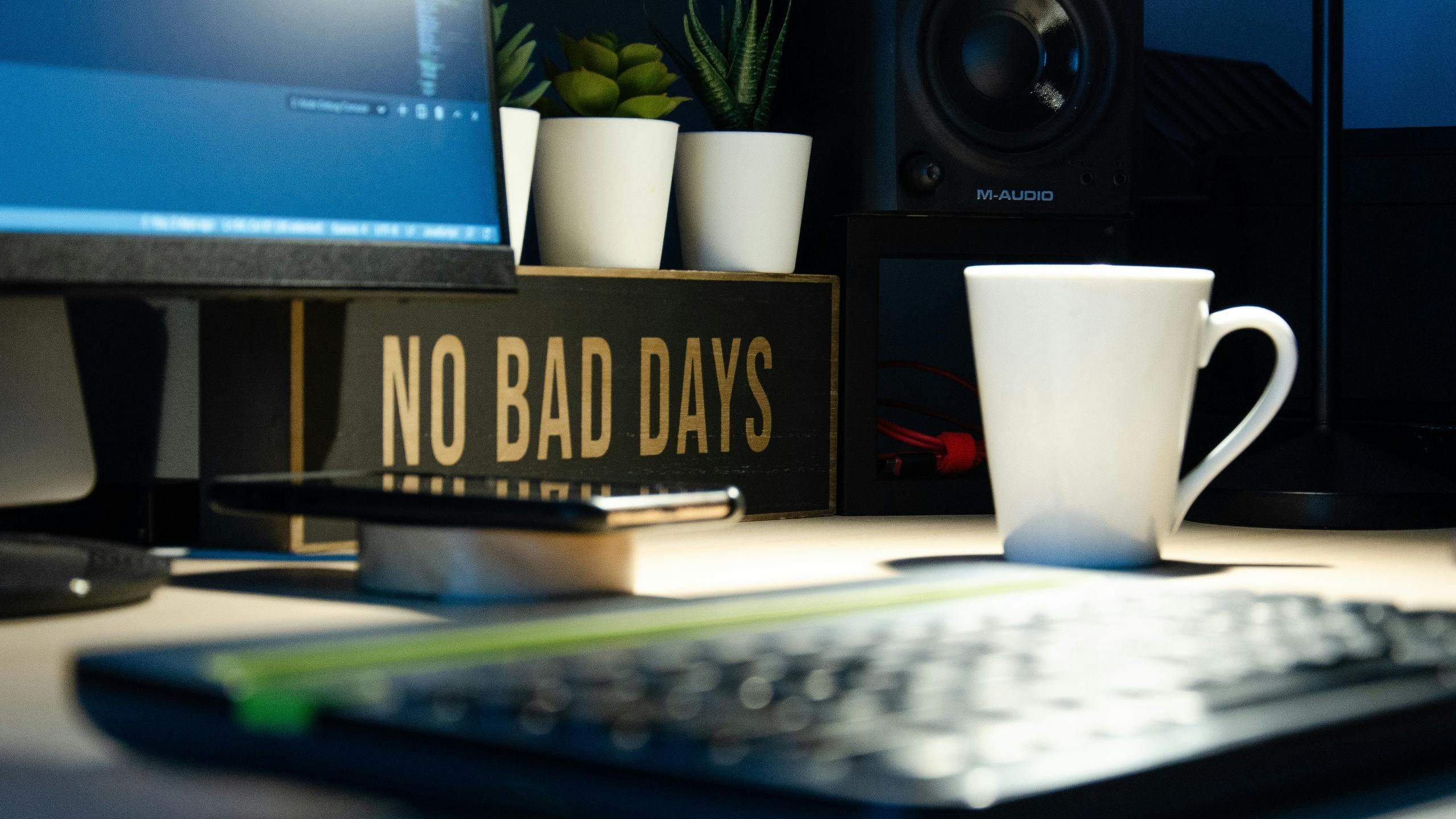 No Bad Days sign on desk next to coffee cup