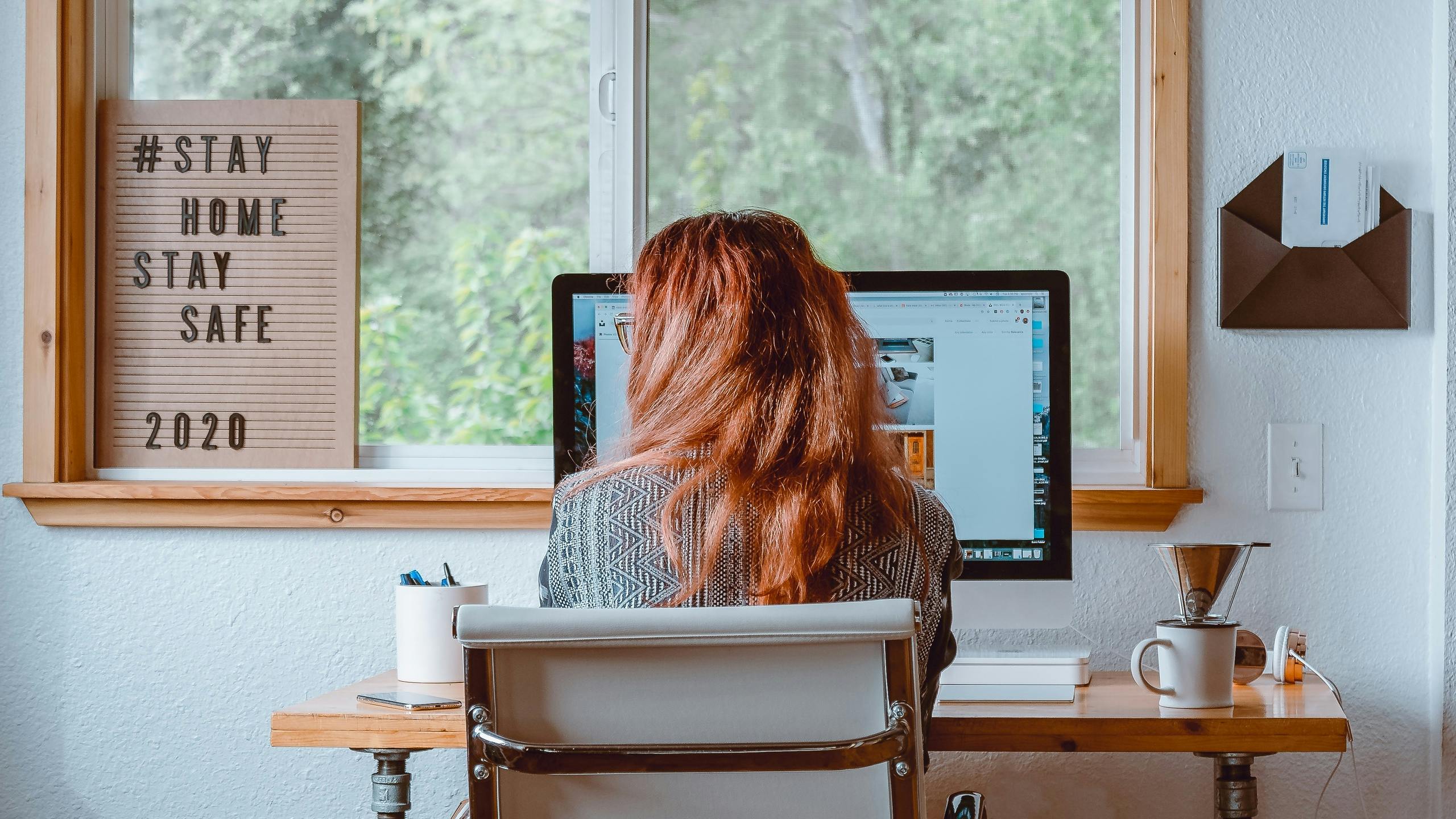 Woman working at computer in home office