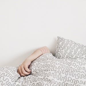 Person sleeping under blankets