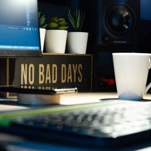 No Bad Days sign on desk next to coffee cup